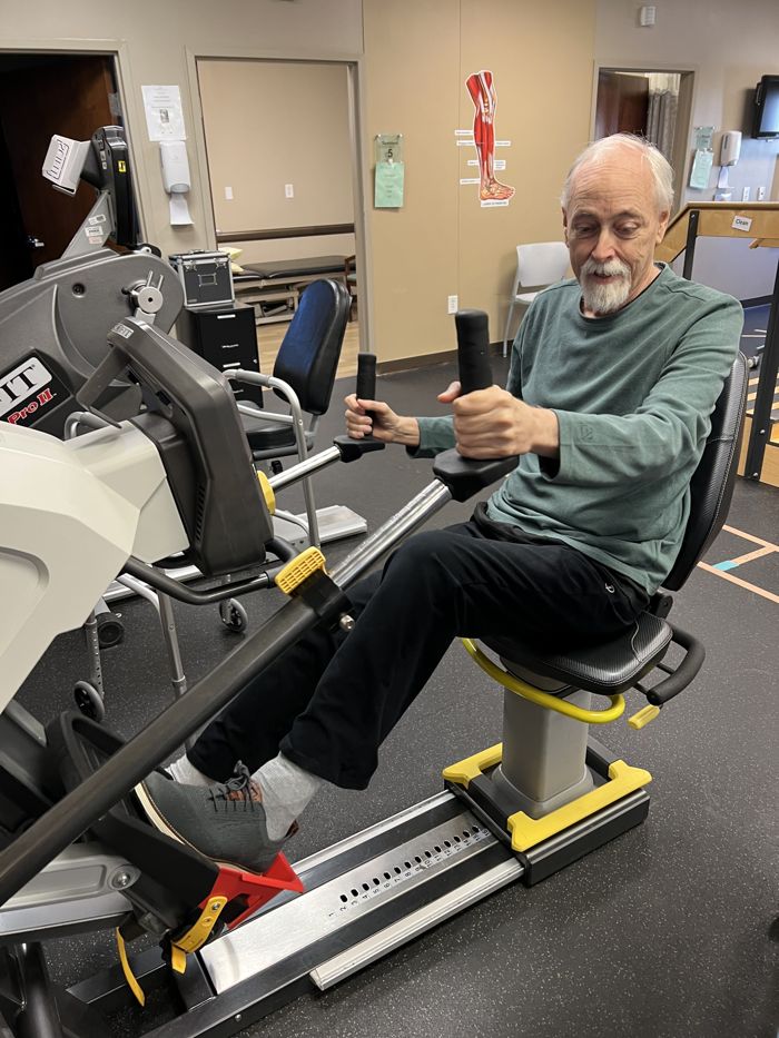 Brian working out on a machine during rehab